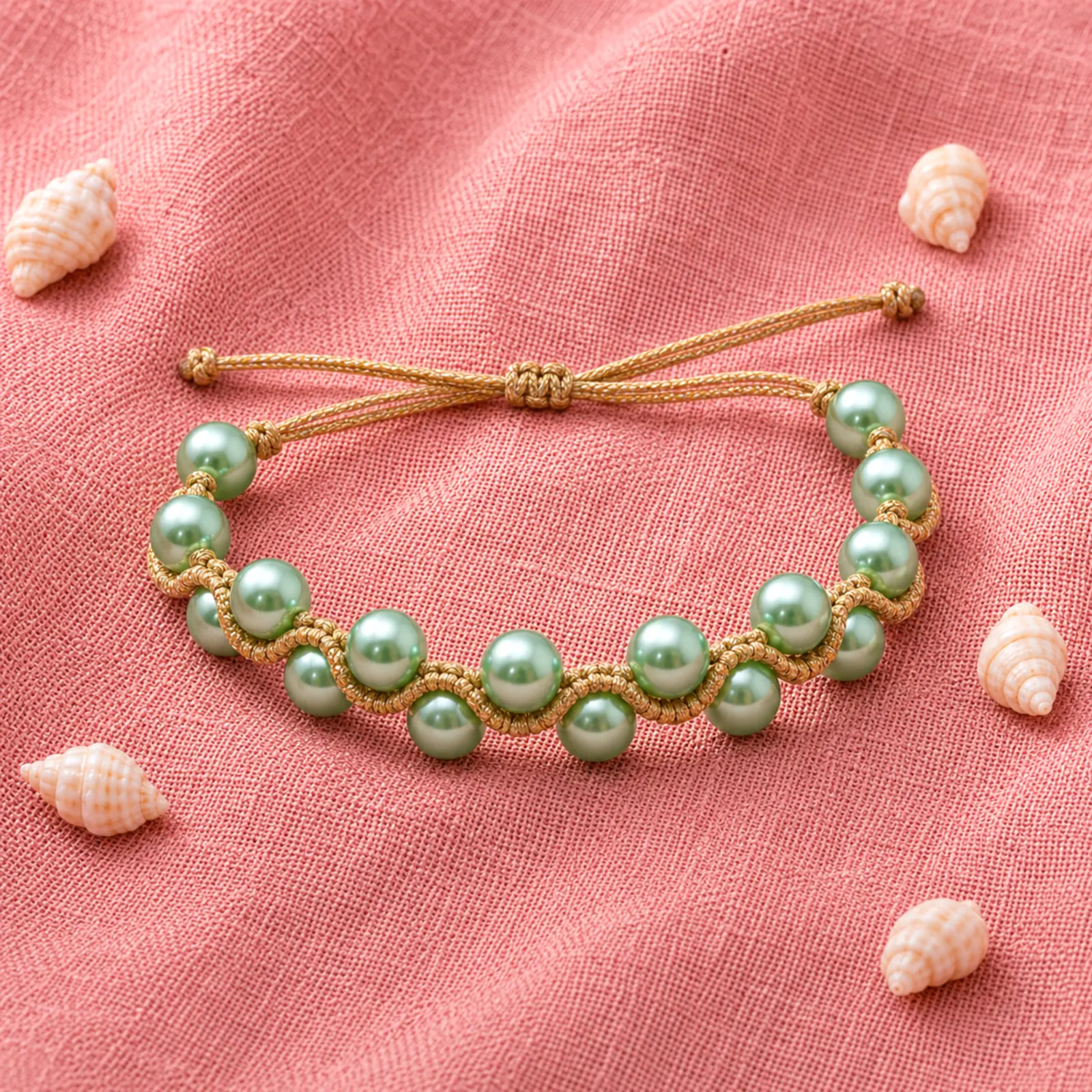 Handmade Macramé Bracelet Wave Pearl Green Gold Metal Gold Pillow in Green and Gold. Styled Image.