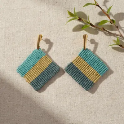 Handmade Macramé Earrings Ocean Line in Blue and Gold. Styled Image.