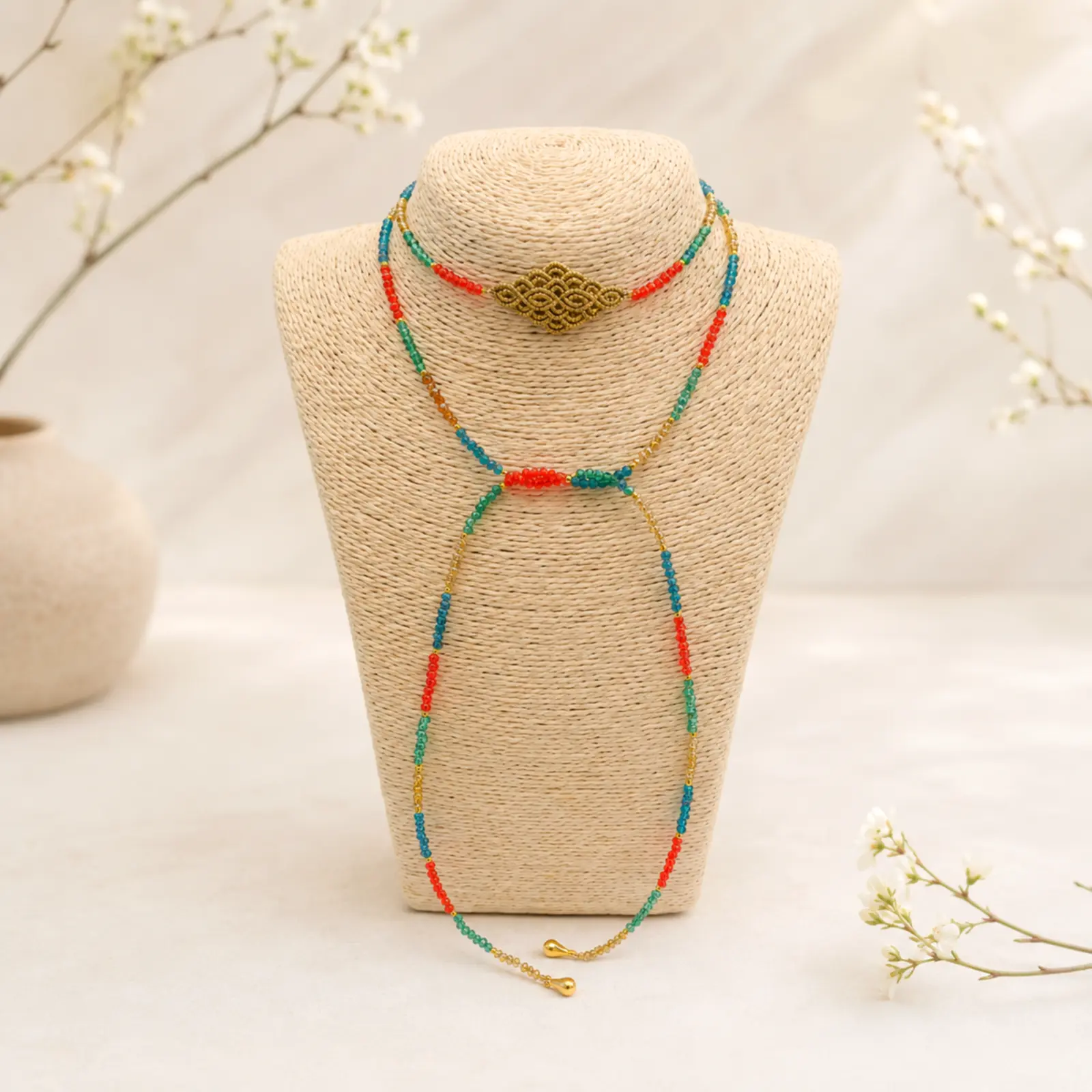 Handmade Macramé Necklace Nomad Loop in Red and Turquoise. Styled Image.